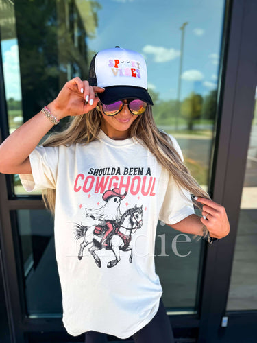 Birdie Shoulda Been A Cowghoul ivory graphic tee featuring a bold cowghoul illustration on soft cotton fabric.