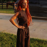 Washed black sleeveless jogger jumpsuit with relaxed fit and drawstring waist, styled as a skirt, by blueivy.