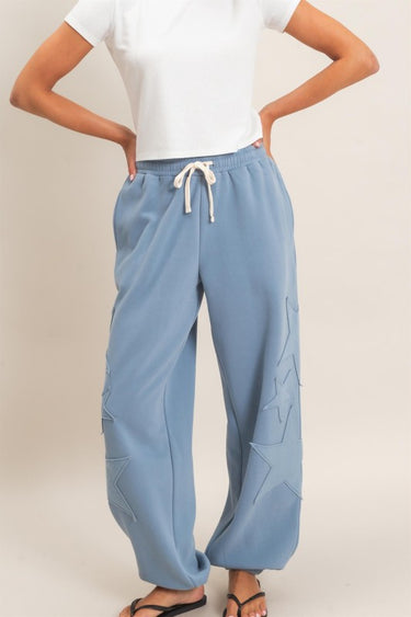 HYFVE Starstruck appliqué lounge pants in dusty blue, featuring a relaxed fit and celestial star design.