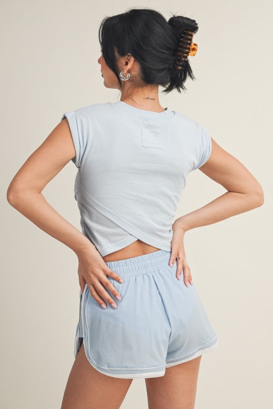 Kimberly C crossover top in blouse style, featuring a stylish front wrap design and long sleeves, perfect for casual or office wear.