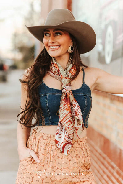 Lucky & Blessed beige cow skull printed wild rag, stylish accessories scarf with tooled design and western-inspired pattern.
