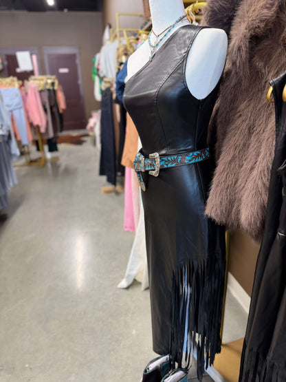 Black faux leather side fringe dress with cut-out waist by Lucky & Blessed, featuring a stylish silhouette and flowing fringe details.