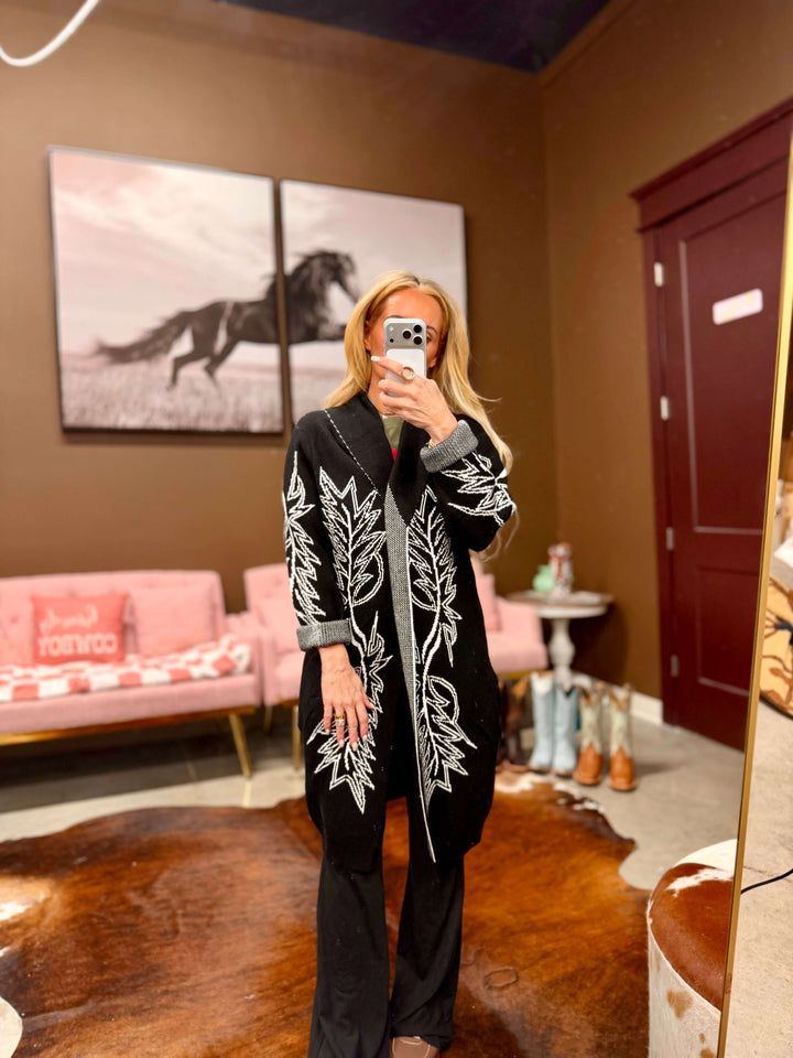Black embroidered open front cardigan by Lucky & Blessed, featuring Western-inspired design and short sleeves, displayed on a model.