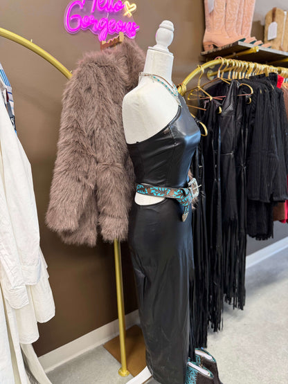 Black faux leather dress with side fringe, W cut-out waist, by Lucky & Blessed, shown on a model.