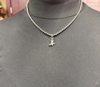 14-inch 18K gold plated dainty beaded necklace with cowboy boot charm by West & Co. on a simple background.
