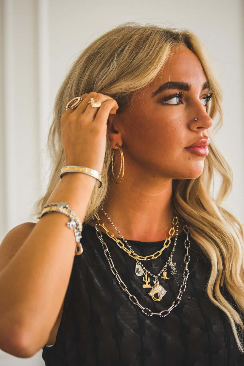 18-inch West & Co. two-tone plated Western charm necklace with intricate Western-themed pendant and chain detail.