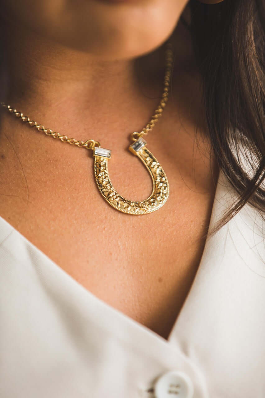 18-inch 18K gold plated horse shoe necklace with rhinestone accents by West & Co. Jewelry accessory featuring a detailed horse shoe design.