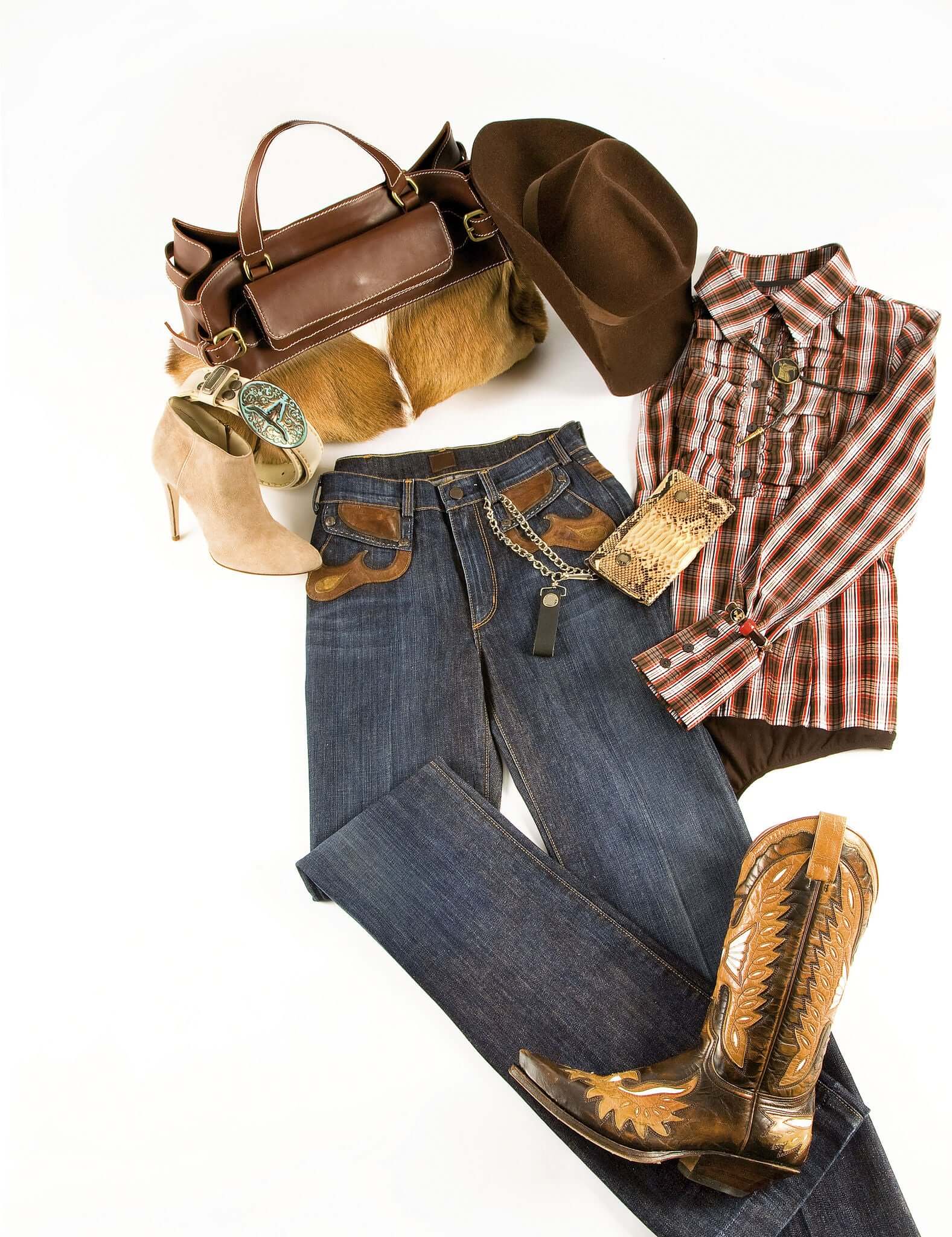 Collection of western-themed clothing and accessories including jeans, cowboy boots, a hat, and a handbag on a white background.