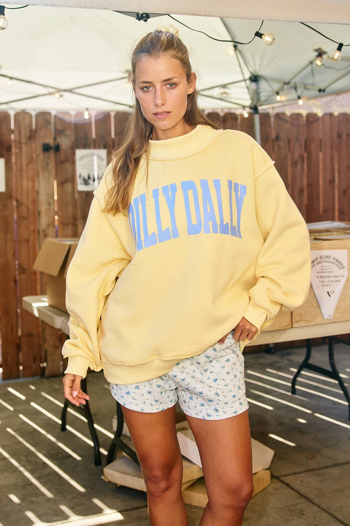 Black Dilly Dally mockneck sweatshirt by BUCKETLIST INC, featuring a relaxed fit and soft fabric, displayed on a hanger.