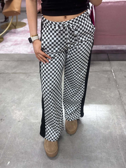 Stylive checkered lounge pants with a relaxed fit and elastic waistband, featuring a black and white checkered pattern.