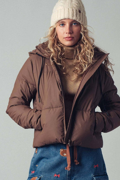 Urban Daizy cozy drawstring hooded puffer jacket, stylish outerwear with a snug hood and puffy insulation for cold weather.