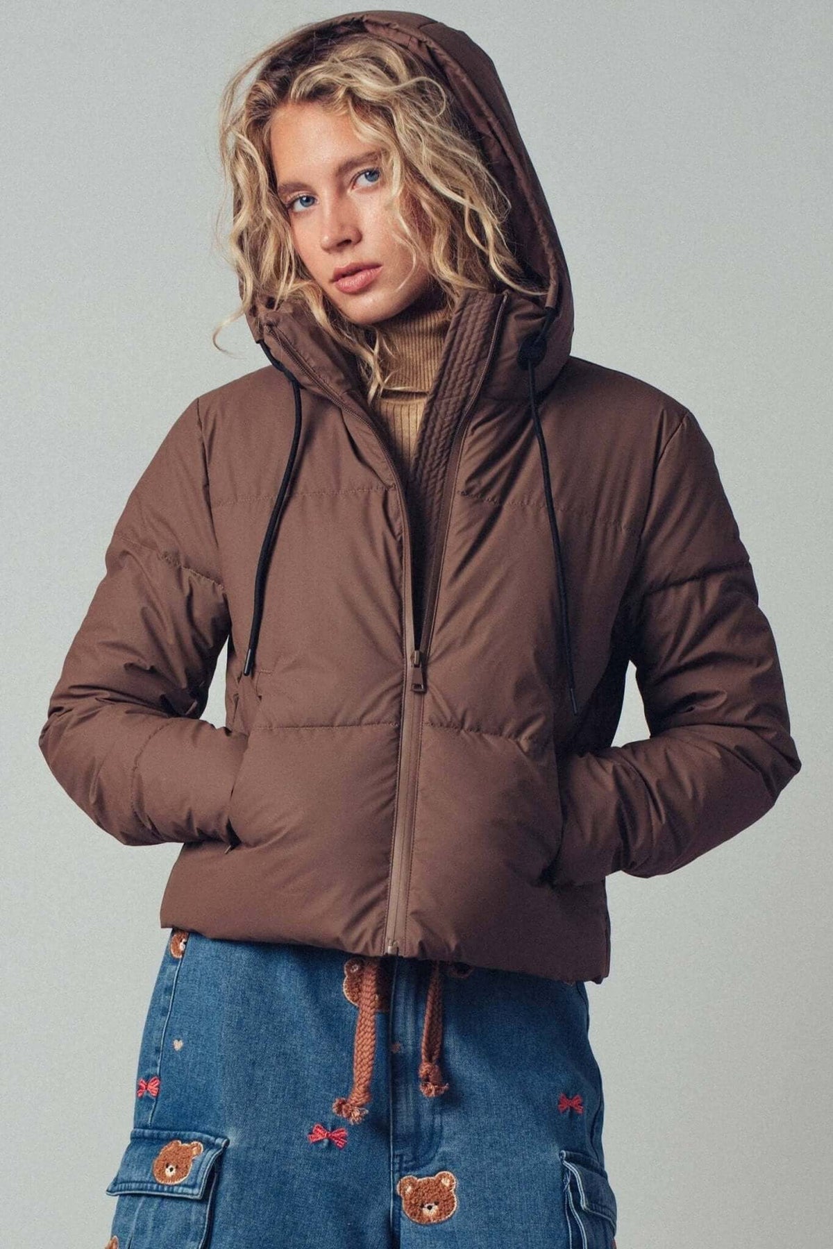 Urban Daizy cozy drawstring hooded puffer jacket, warm outerwear with a padded design and adjustable hood for cold weather.