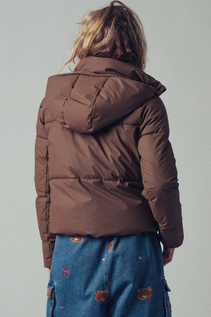 Urban Daizy cozy drawstring hooded puffer jacket, insulated outerwear with a hood and front pockets, suitable for cold weather.