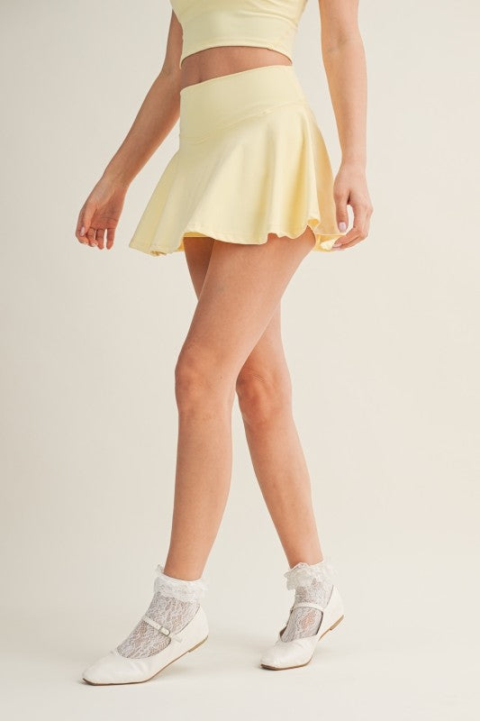 Kimberly C mini circle skort with bow back detail, featuring a stylish, fitted skirt with a playful bow accent at the back.