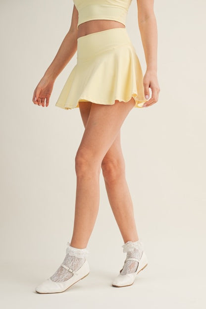 Kimberly C mini circle skort with bow back detail, featuring a stylish, fitted skirt with a playful bow accent at the back.