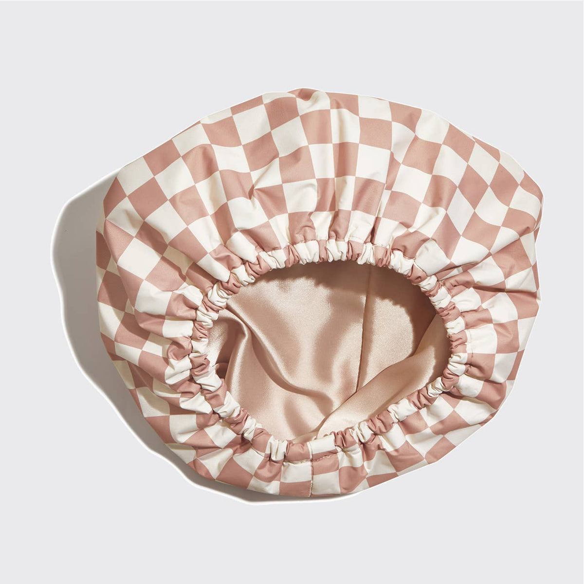 KITSCH satin-lined flexi shower cap with terracotta checker pattern, waterproof design, and adjustable fit for hair protection.