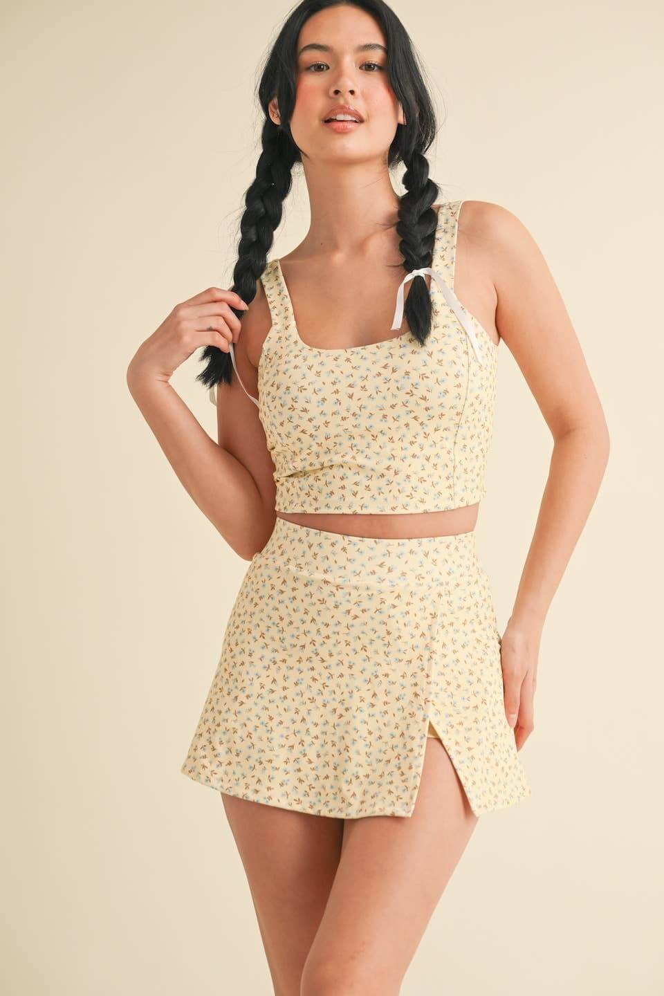 Kimberly C Ditsy Print Twist Back Crop Tank top with delicate floral pattern and twisted back detail, perfect for casual wear.