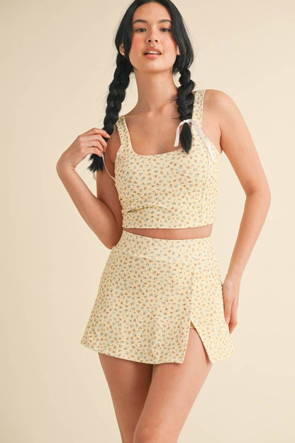 Kimberly C Ditsy Print Twist Back Crop Tank top with delicate floral pattern and twisted back detail, perfect for casual wear.