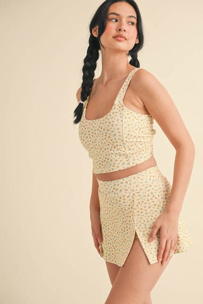 Ditsy print twist-back crop tank top by Kimberly C, featuring a stylish back twist design and lightweight fabric.