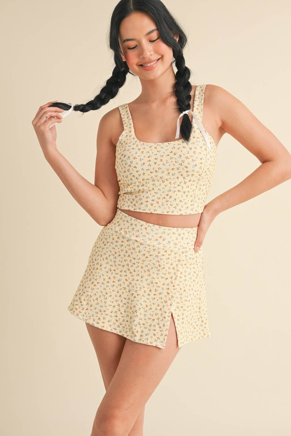 Ditsy print twist-back crop tank top by Kimberly C, featuring a stylish back twist detail and lightweight fabric.