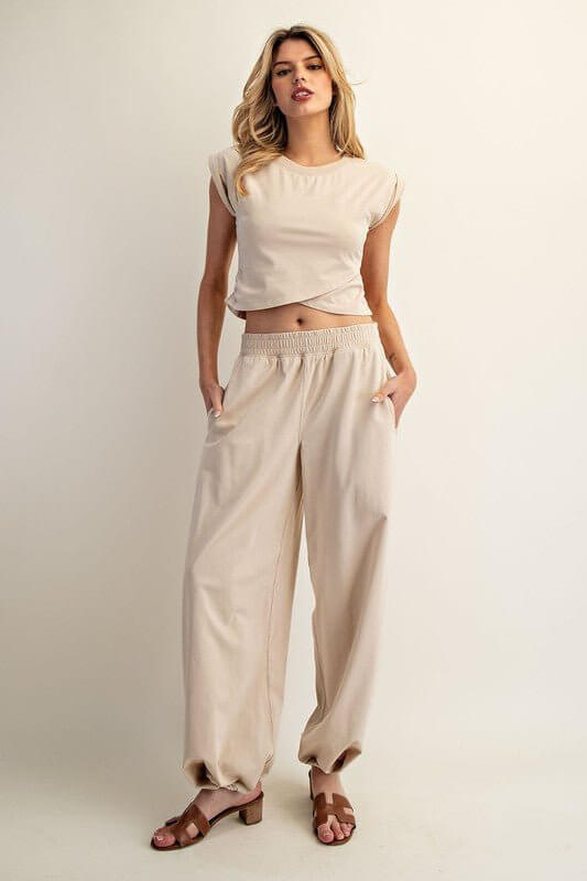 Ee:some sleeveless crop top paired with elastic-waist lounge pants in a comfortable loungewear set.