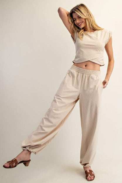 ee:some sleeveless crop top paired with elastic-waist lounge pants in a comfortable loungewear set.
