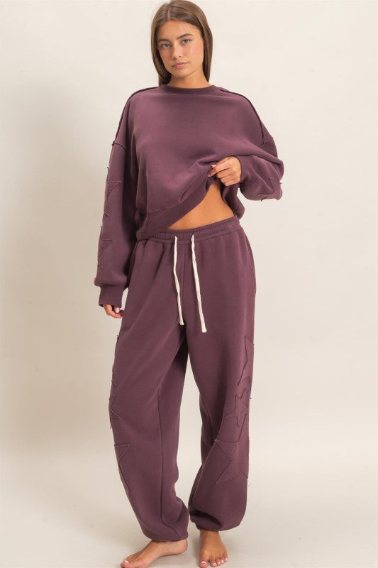 Hyfve plum star sleeve oversized sweatshirt with cozy, relaxed fit and star pattern on the sleeves, perfect for casual wear.