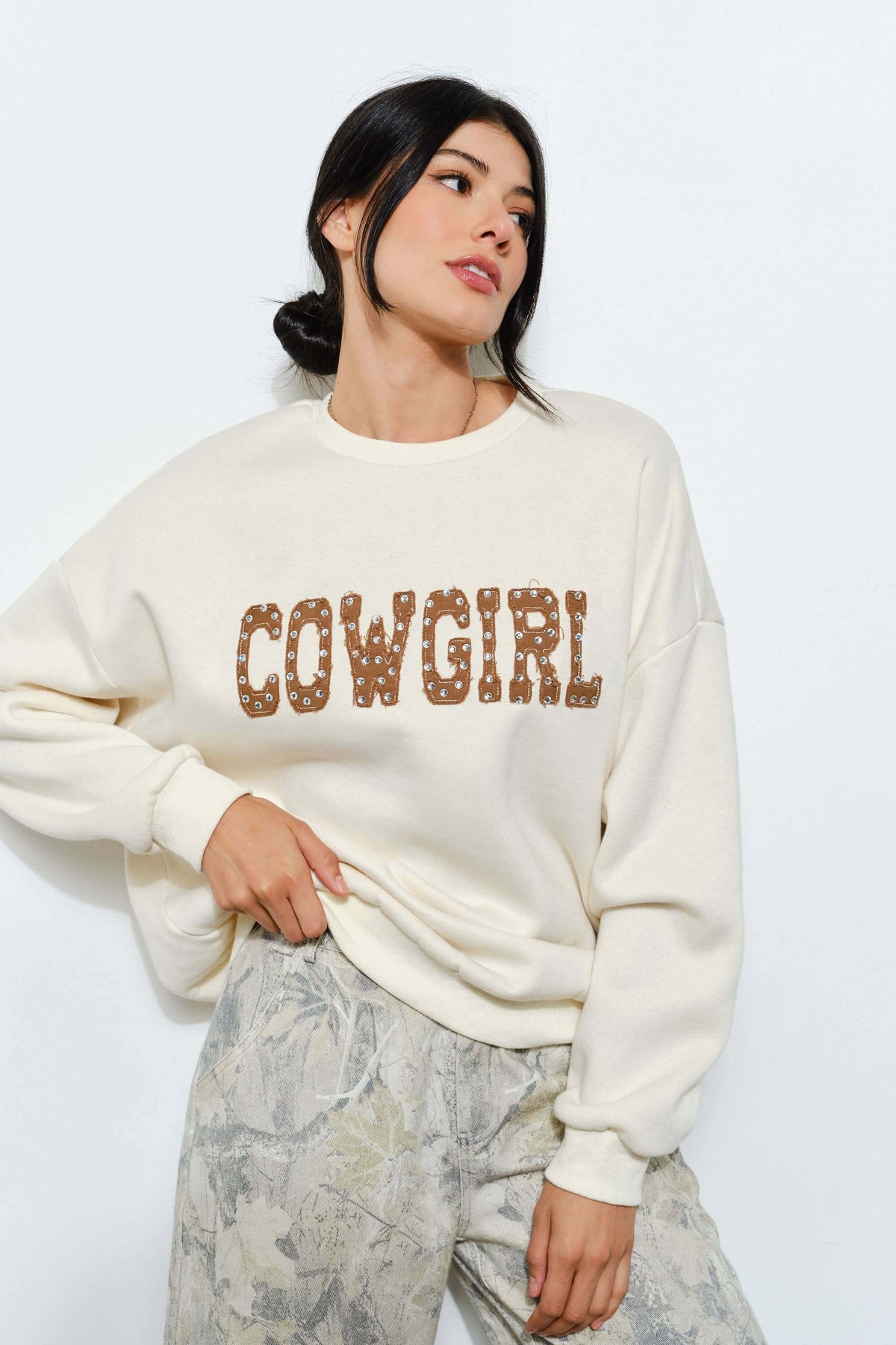 Brie Rhinestone Cowgirl Western sweatshirt by Pretty Garbage with graphic cowgirl design and rhinestone accents on soft fabric.