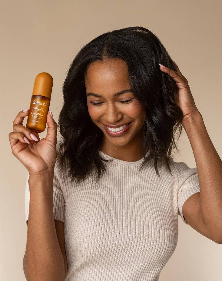 KITSCH Caramel Cream Hair and Body Perfume Mist spray bottle with caramel-colored liquid and floral design cap.