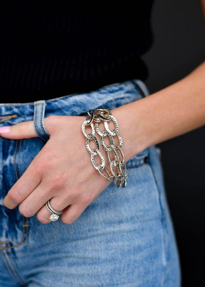 Hammered silver three-strand chain toggle bracelet from West & Co. featuring textured metal links and a toggle clasp.