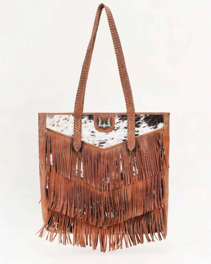 Loyal West Myra bag with fringe and cowhide design, large purse featuring natural leather texture and stylish details.