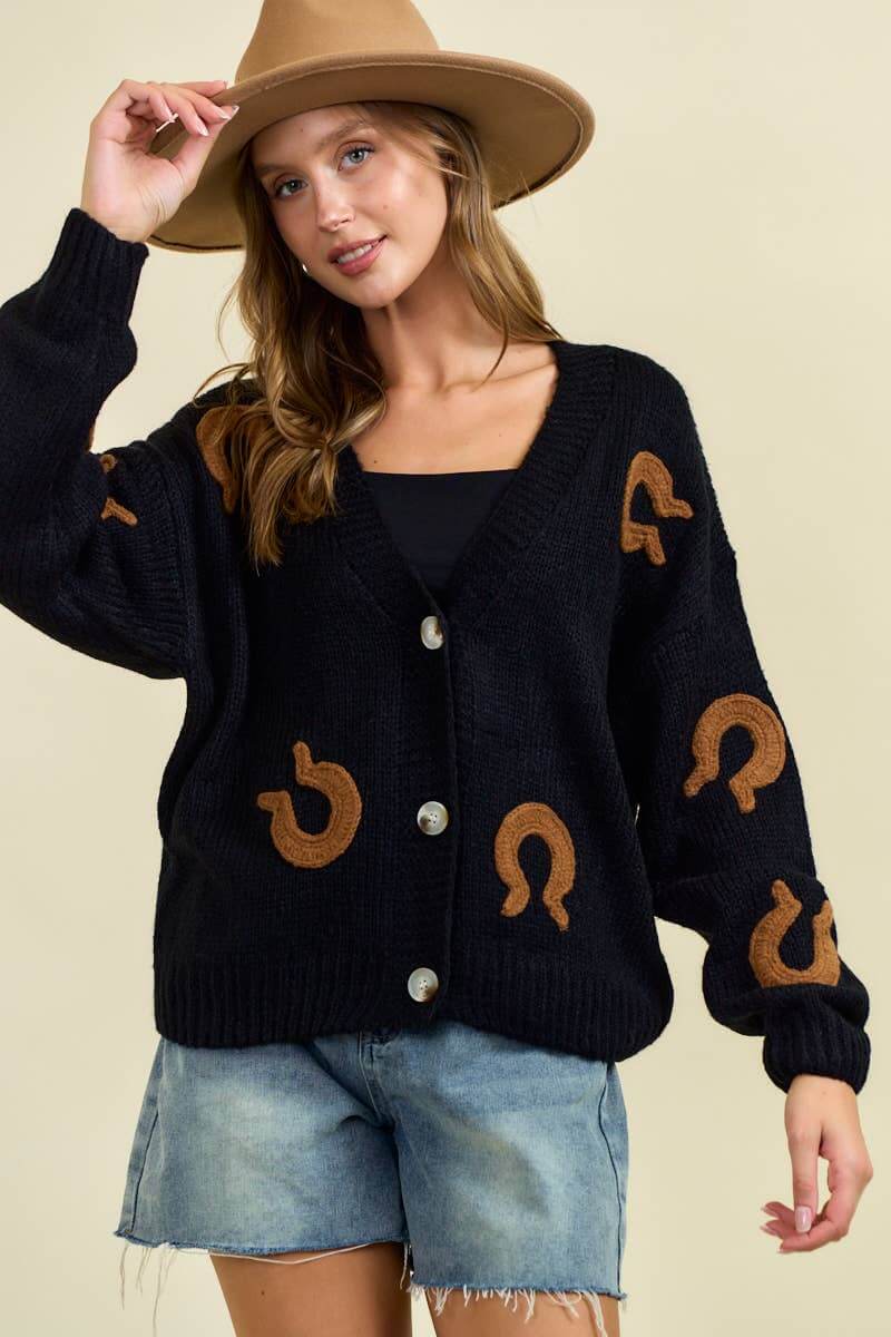 Doe and Rae horseshoe patch cardigan, cozy knit sweater with decorative horseshoe patches on the sleeves and front.