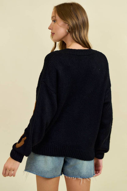 Doe and Rae horseshoe patch cardigan, a cozy knit sweater featuring a decorative horseshoe patch on the front.