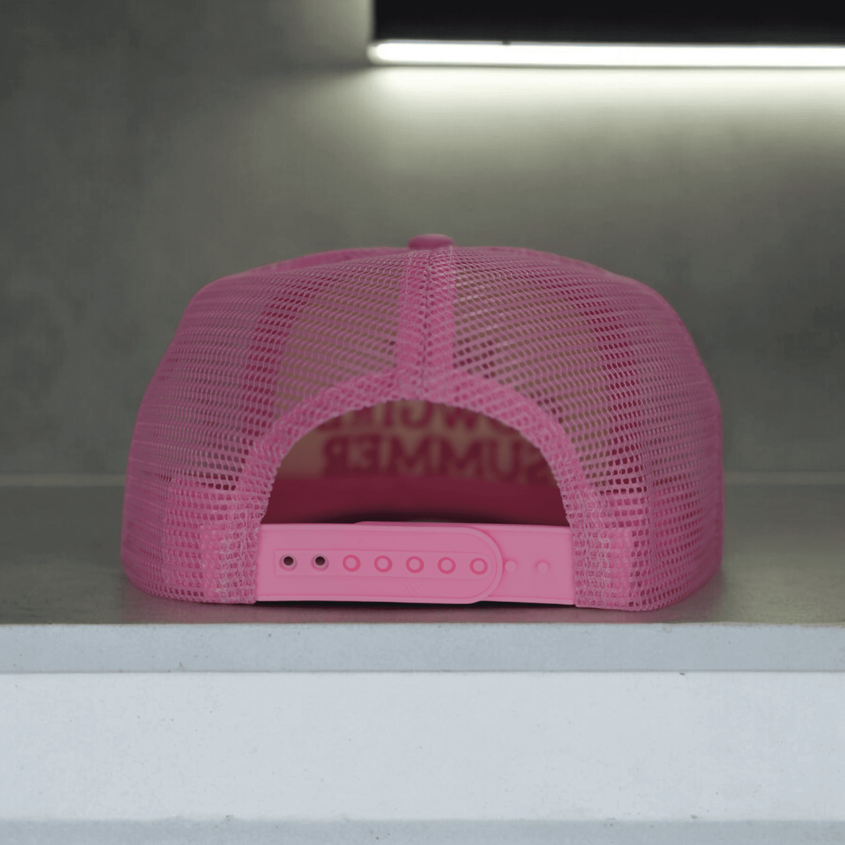 Light pink embroidered cowgirl summer trucker hat by Wilde Roots, featuring classic mesh back and adjustable strap.