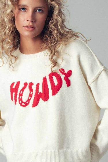 Urban Daizy Howdy Slogan Relaxed Knit Sweater featuring a casual fit and bold lettering on soft, cozy fabric.