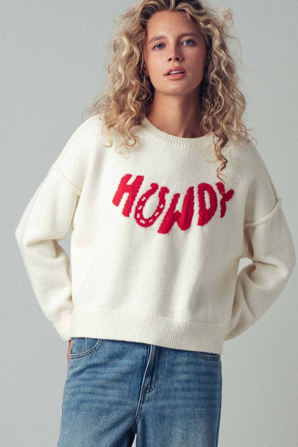 Urban Daizy Howdy slogan relaxed knit sweater with a cozy, casual fit and bold lettering on the front.
