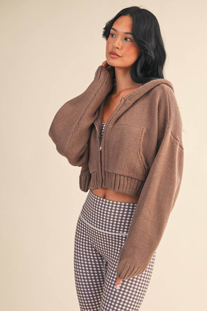 KIMBERLY C Luxe high-waist satin midi skirt in silky fabric, styled with a knit zip-up hoodie sweater.