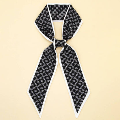 ACCITY Letter Floral Twilly Scarf used as hair ribbon and bag tie, featuring vibrant floral and letter patterns.