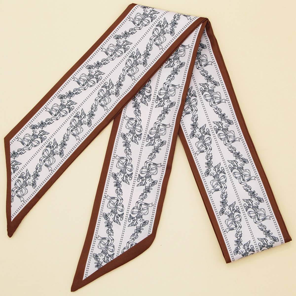 ACCITY Letter Floral Twilly Scarf used as hair ribbon and bag tie, featuring vibrant floral and letter patterns.
