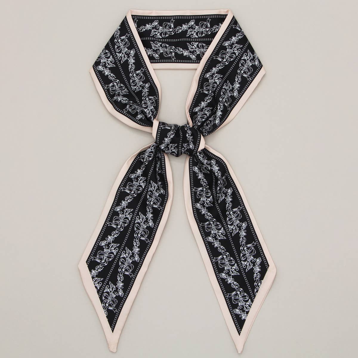 ACCITY Letter Floral Twilly Scarf used as a hair ribbon and bag tie, featuring vibrant floral and letter patterns.