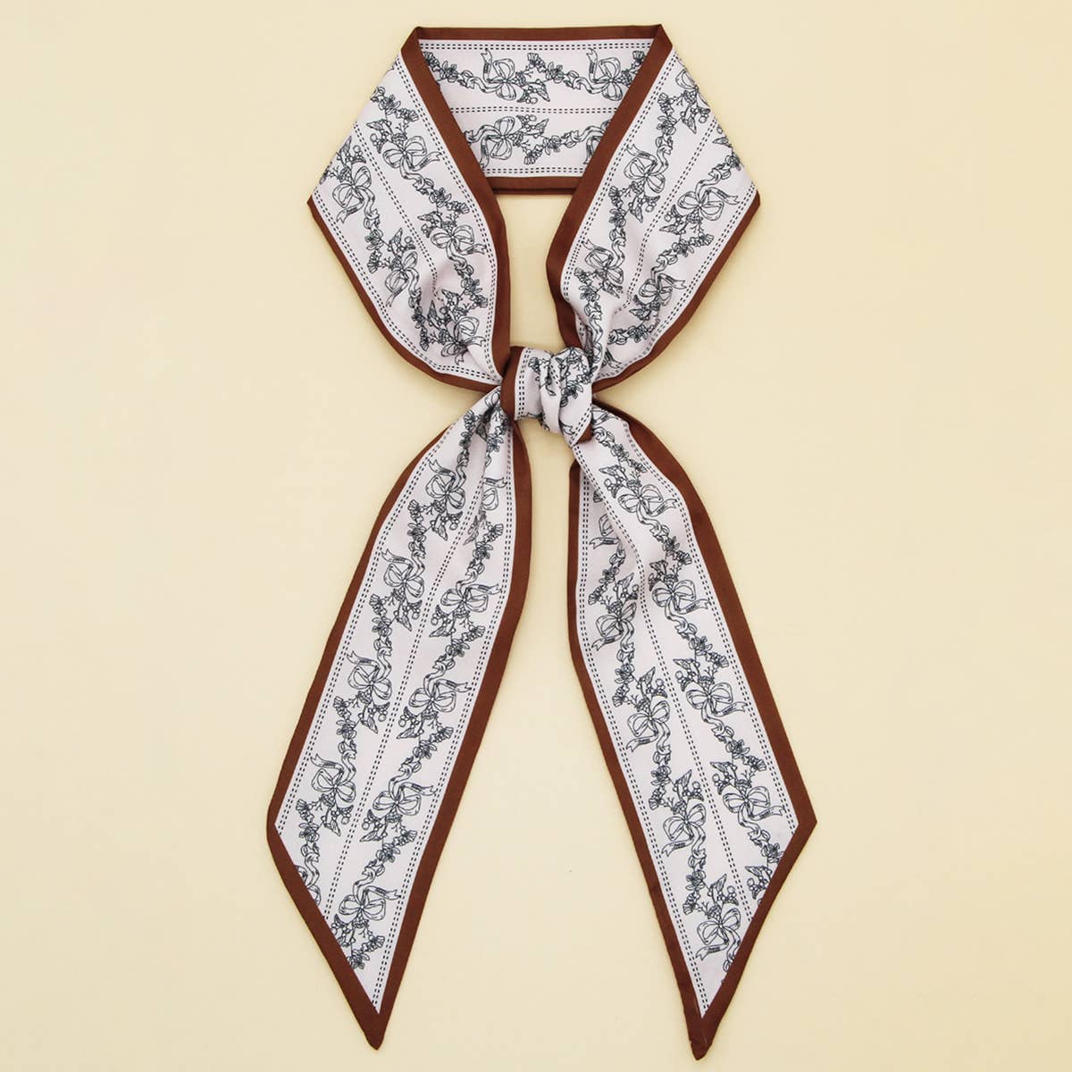 ACCITY Letter Floral Twilly Scarf used as a hair ribbon and bag tie, featuring vibrant floral and letter patterns.