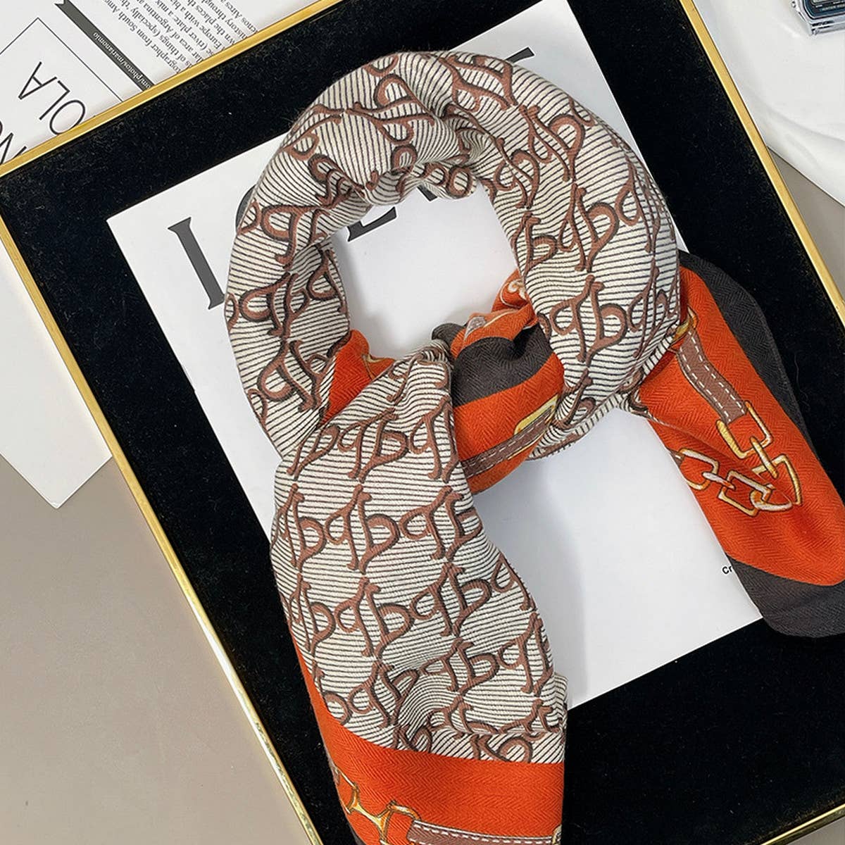 ACCITY luxury chain print velvet scarf wrapped around neck, showcasing elegant design and rich fabric texture.
