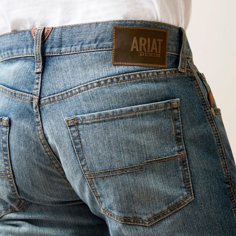 Ariat M5 Straight Hansen Jean showing classic straight-leg denim with five-pocket design and branded leather patch on waistband.