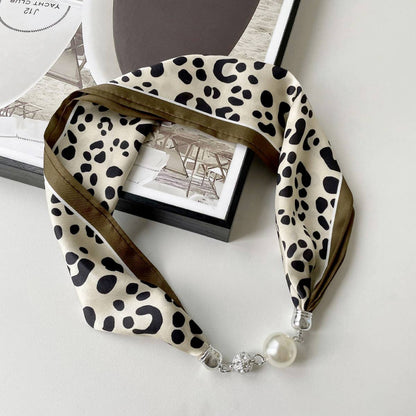 Elegant magnetic silk scarf necklace by ACCITY, showcasing a stylish neck wrap with a smooth, glossy finish and intricate design.