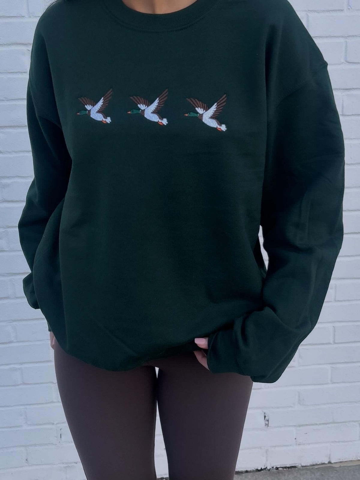 Gray embroidered sweatshirt featuring a detailed mallard duck graphic by Dash Forward Wholesale.