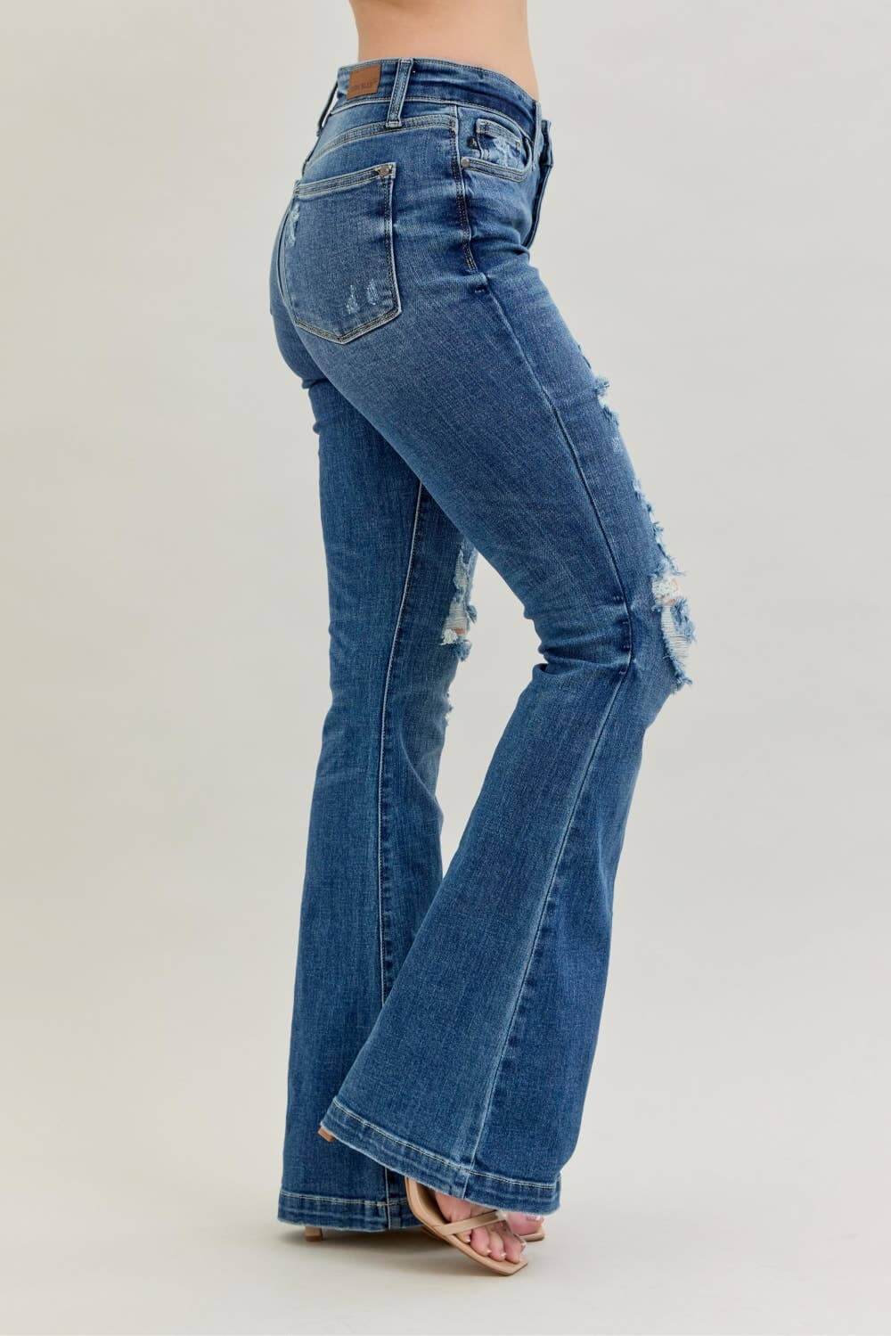 Distressed Judy Blue midrise button fly flare jeans with distressed details and classic denim style, designed for a trendy casual look.