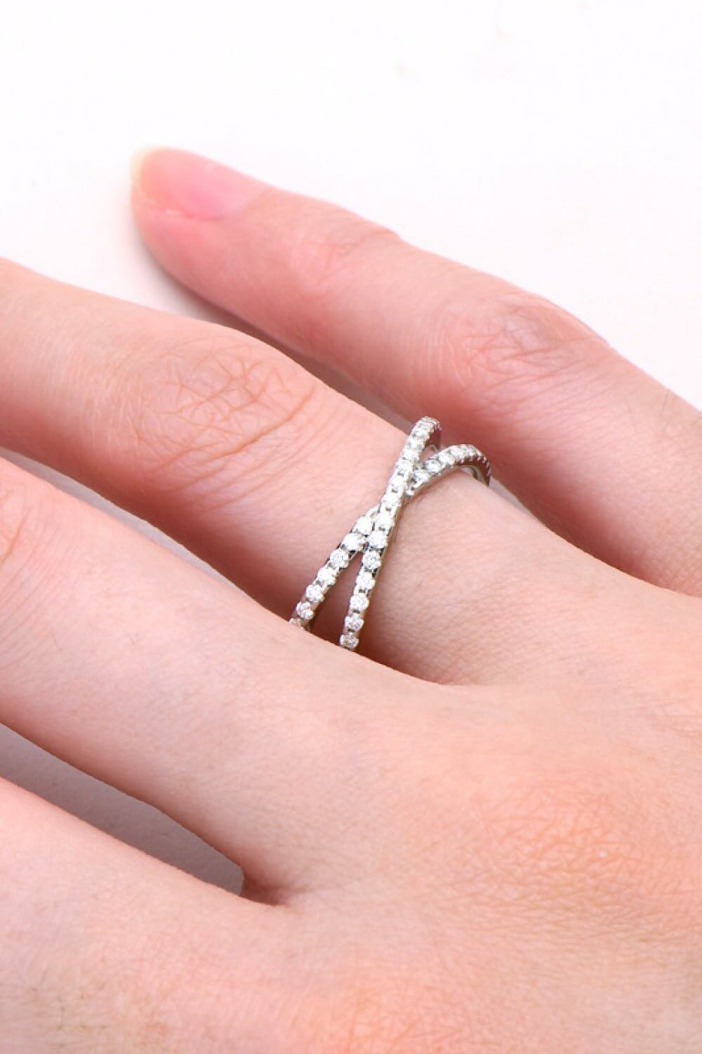 Sterling silver Moissanite crisscross ring with infinity design and 0.40 CT sparkling stones, elegant jewelry accessory.