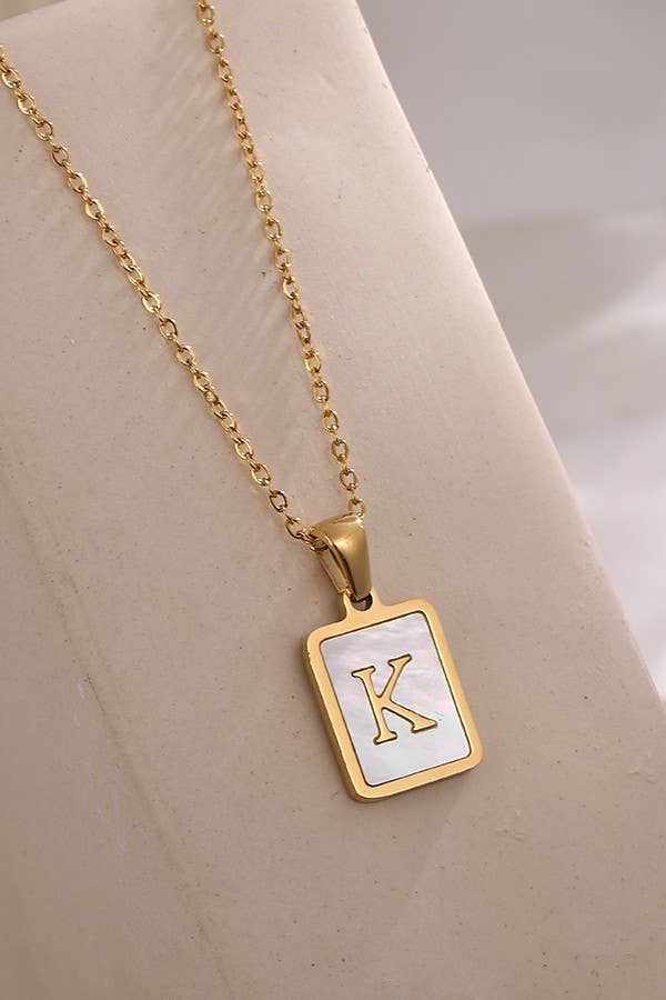 Stainless steel tarnish-free initial necklace by JOSSLYN, featuring a sleek, polished pendant with a chain, jewelry accessory.