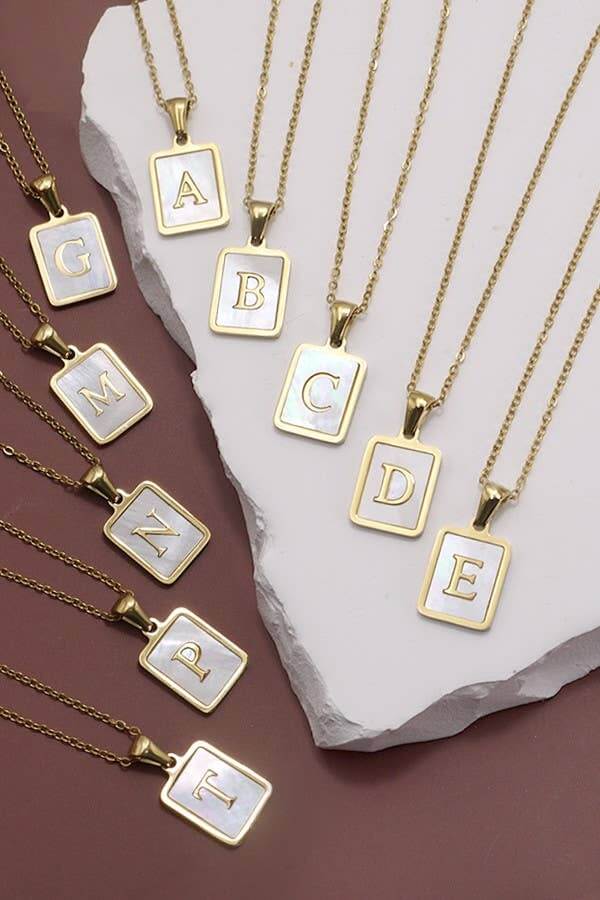 Stainless steel tarnish-free initial necklace by JOSSLYN, featuring a sleek pendant with a personalized letter design.
