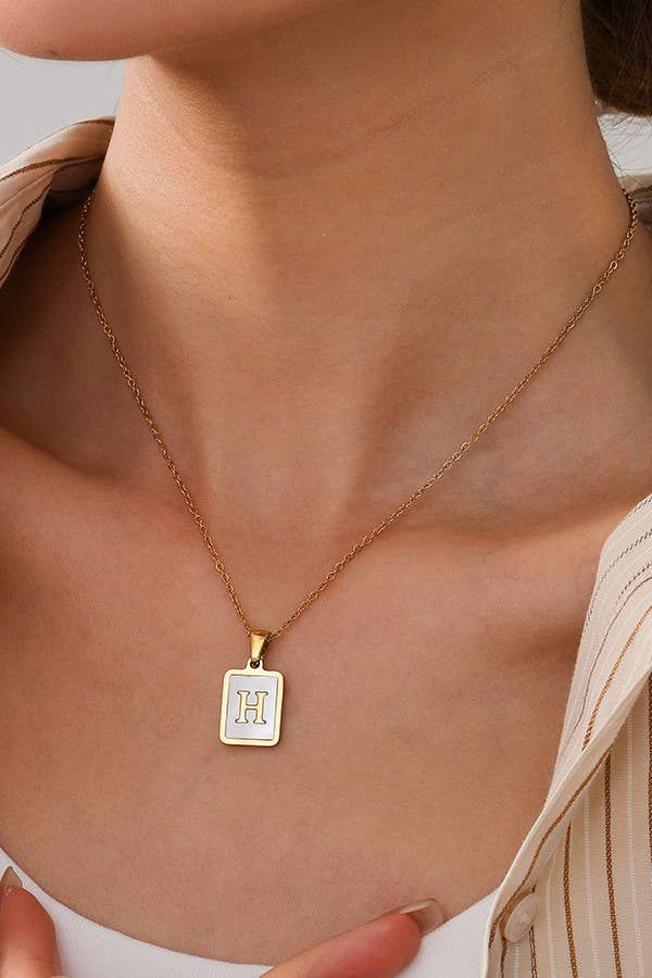 Stainless steel tarnish-free initial necklace by JOSSLYN, stylish jewelry accessory with a sleek, polished finish.